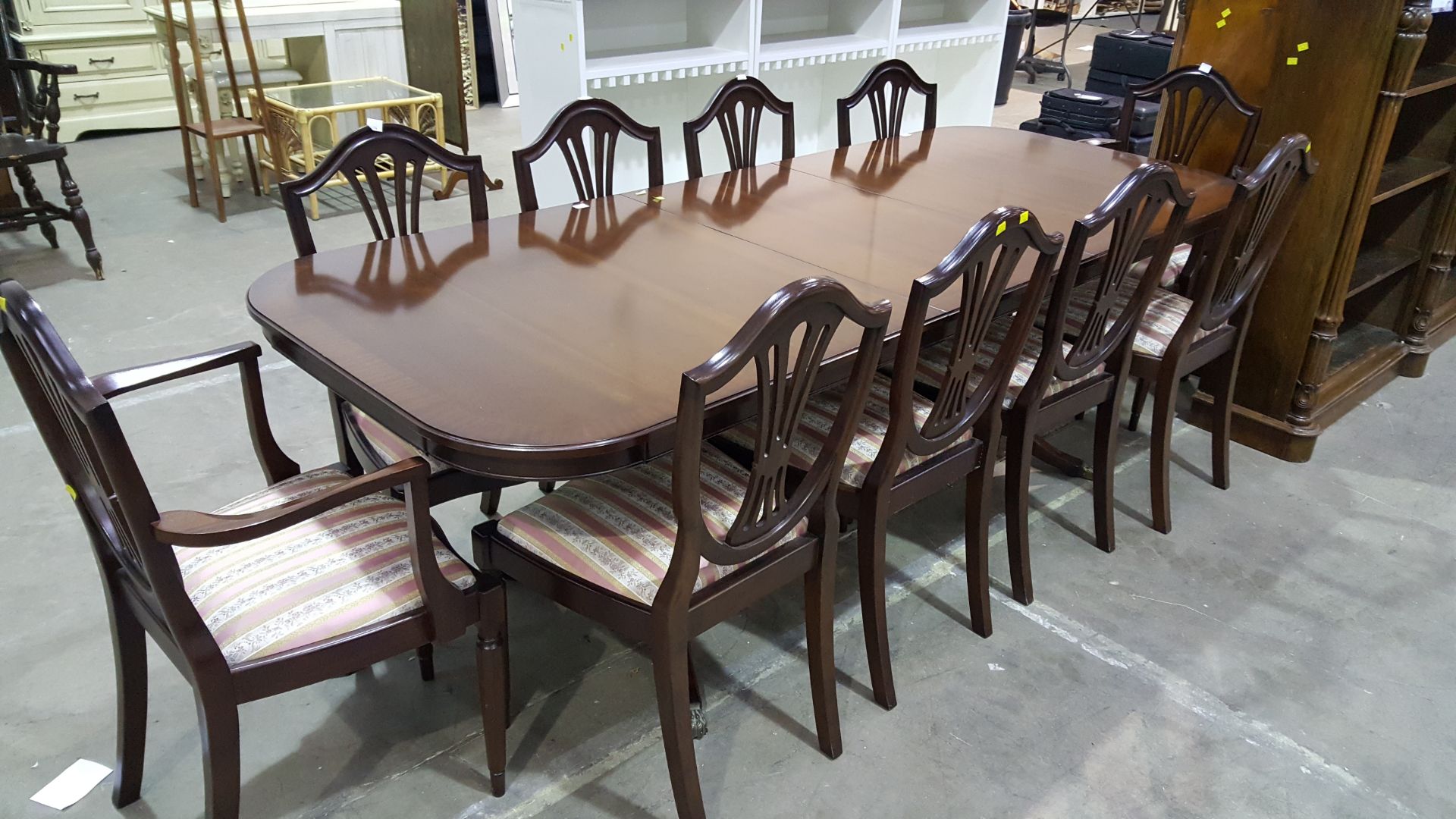 An Extending Dark Dining Table with Two Carver Cha