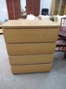 Gold coloured framed mirror with four drawer chest of drawers