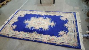A dark blue with floral (chineses?)design rug & Ikea 'Hampden' rug
