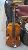 A Cello in soft case with stool