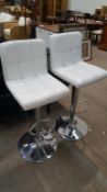 A pair of cream leather effect barstools