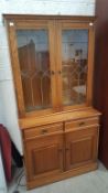 A Bookcase on two drawers over two door cabinet