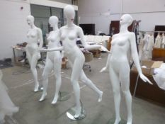 Four mannequins on glass chrome stands