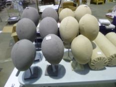 Eleven mannequin heads on stands together with three display rolls