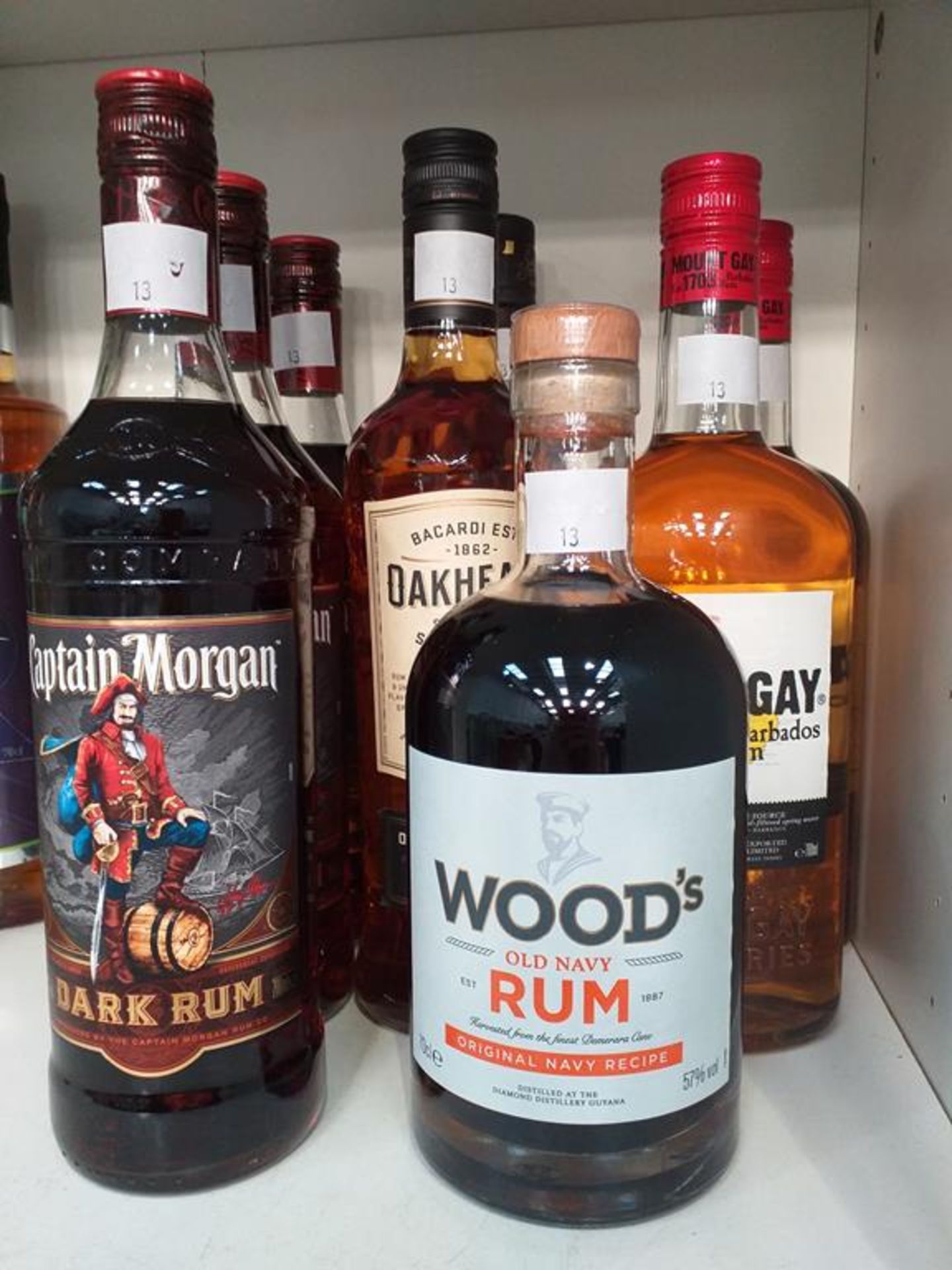 Three bottles of Captain Morgan Dark Rum, a bottle of Wood's Old Navy Rum, two bottles of Mount Gay