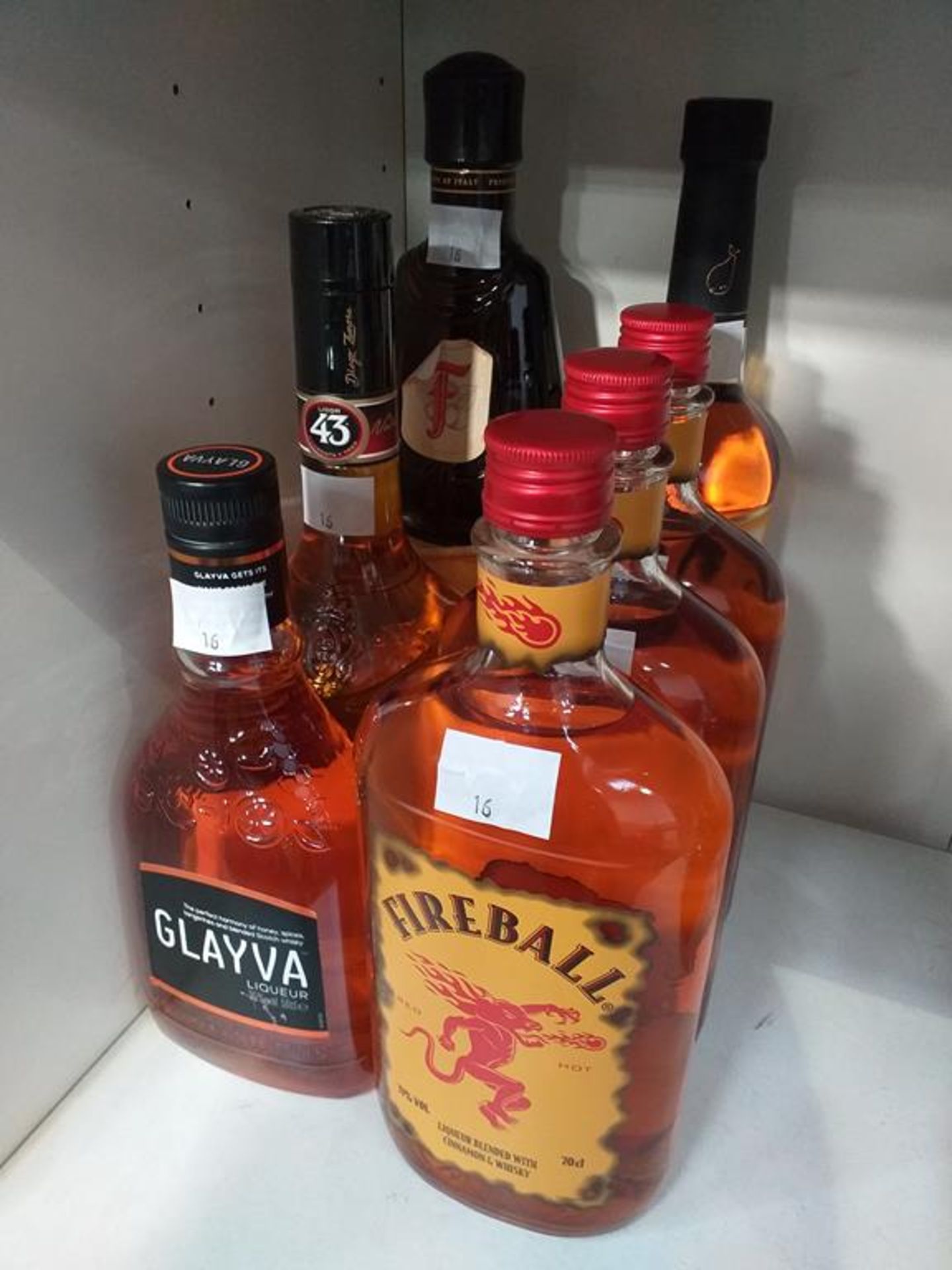 Three bottles of Fireball Liqueur, a bottle of Xante Liqueur, a bottle of Glayva liqueur, a bottle o