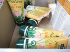 A box of lotions to include Organic Aloe Vera Sun Lotion, Self Tan Lotion