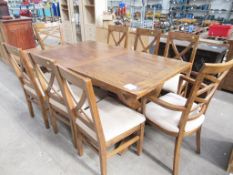 A wooden effect dinning table with eight chairs (W171cm)