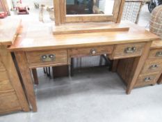 A wooden effect three drawer dressing table (W125cm) and mirror