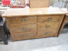 A wooden effect six drawer sideboard (W147cm)