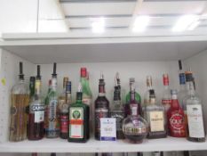 Shelf of part open bottles of spirits including Jack Daniels, Captain Morgan, Clynelish, Martell etc