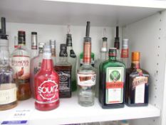 Shelf of part open bottles of spirits including Baileys, Jägermeister, Gordons, Kwai Feh etc