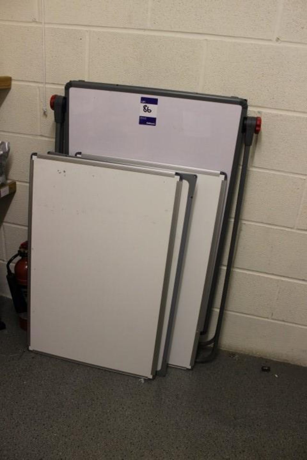 3 wall mounted white boards and a freestanding whi