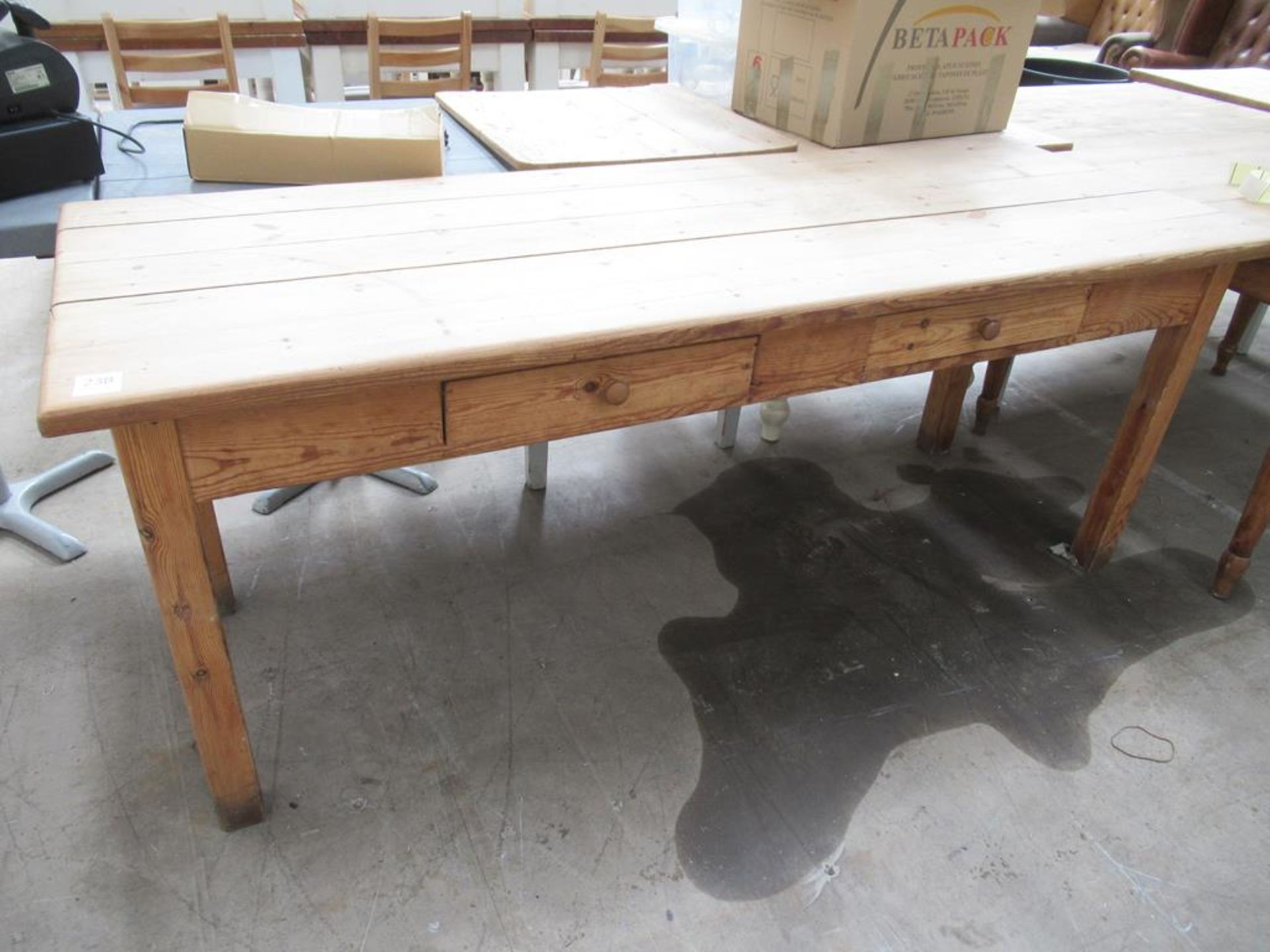 A Wooden Table with Drawers to one end