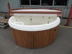 An unbranded circular hot tub.