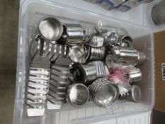 Quantity of stainless steel jugs, bowls and toast racks in plastic crate