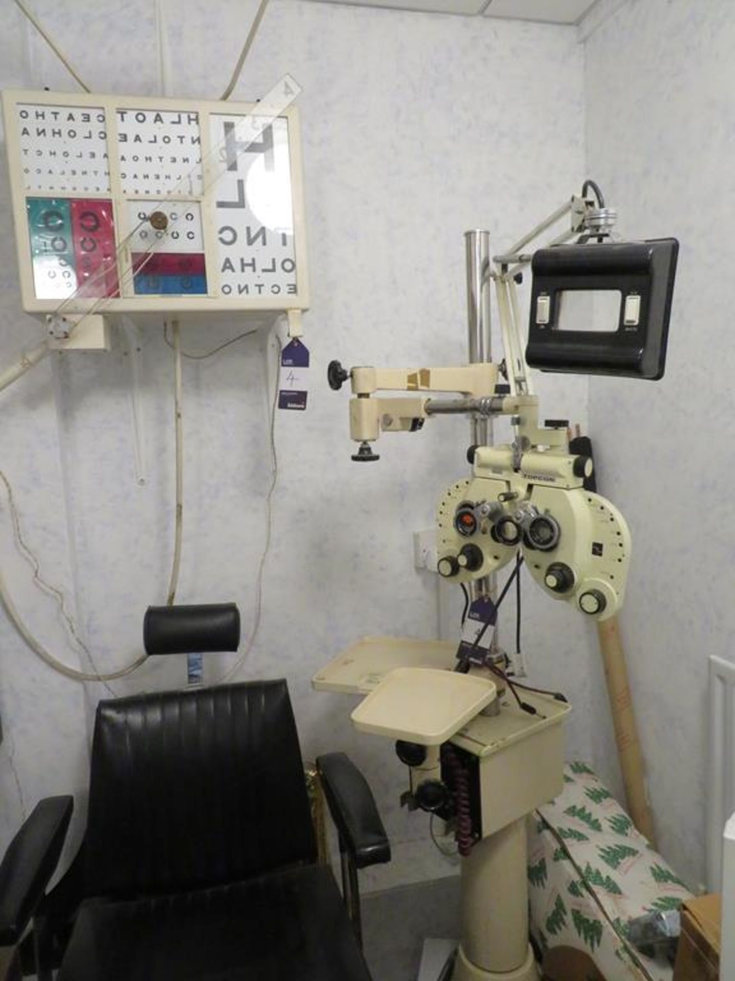 Topcon stand unit with refractor and chair and an eye test wall chart cabinet