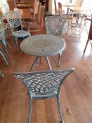 Ornate cast metal table with 2 Oxley's chairs