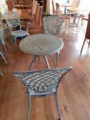 Ornate cast metal table with 4 Oxley's chairs