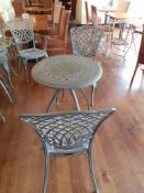 Ornate cast metal table with 2 Oxley's chairs