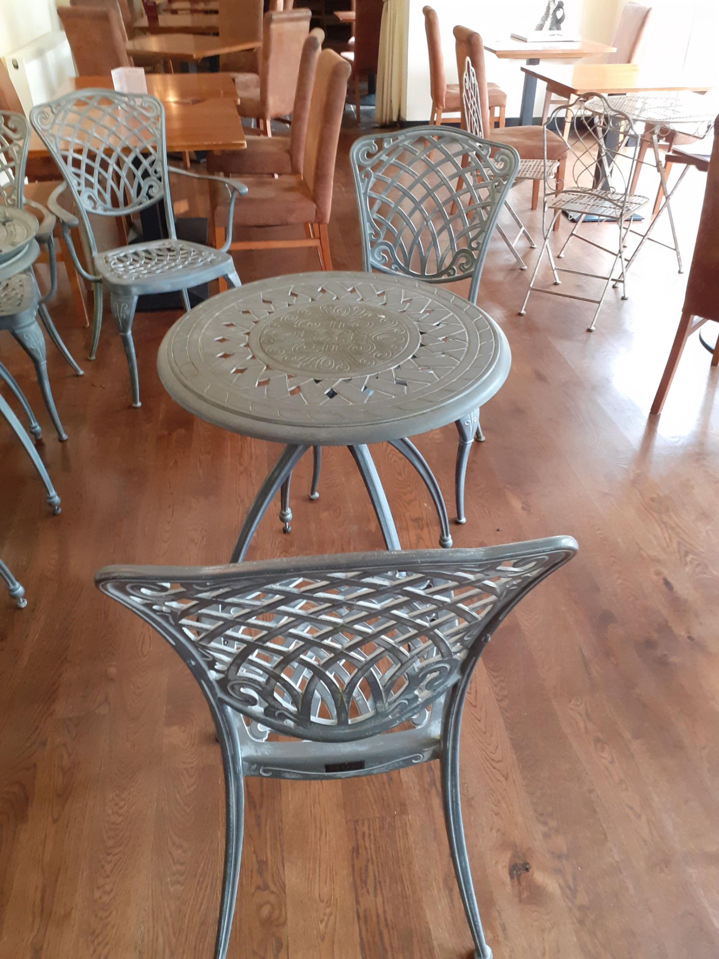 Ornate cast metal table with 2 Oxley's chairs