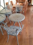 Ornate cast metal table with 2 Oxley's elbow chair