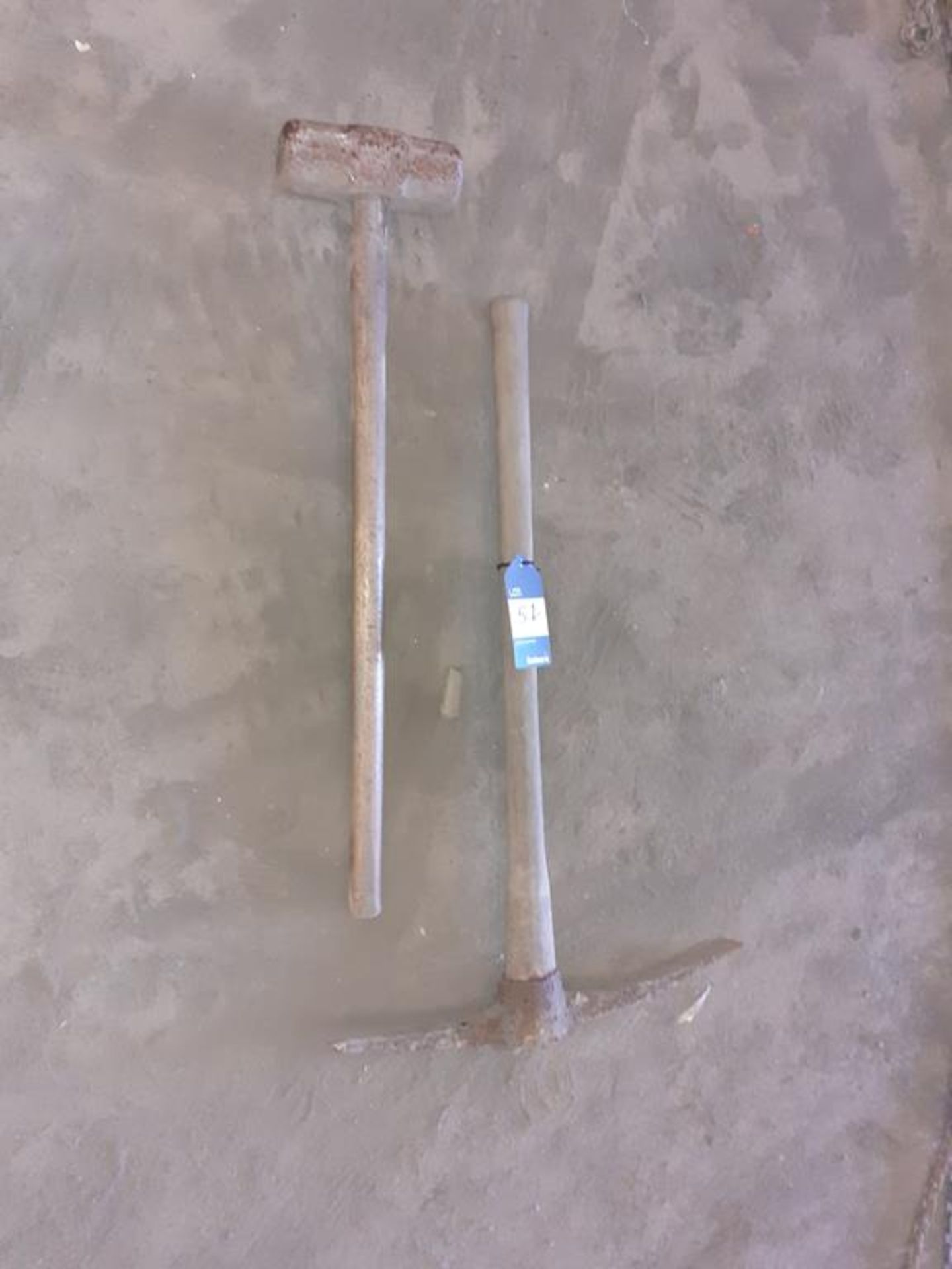 Sledge hammer and pick axe. This lot is Buyer to Remove.