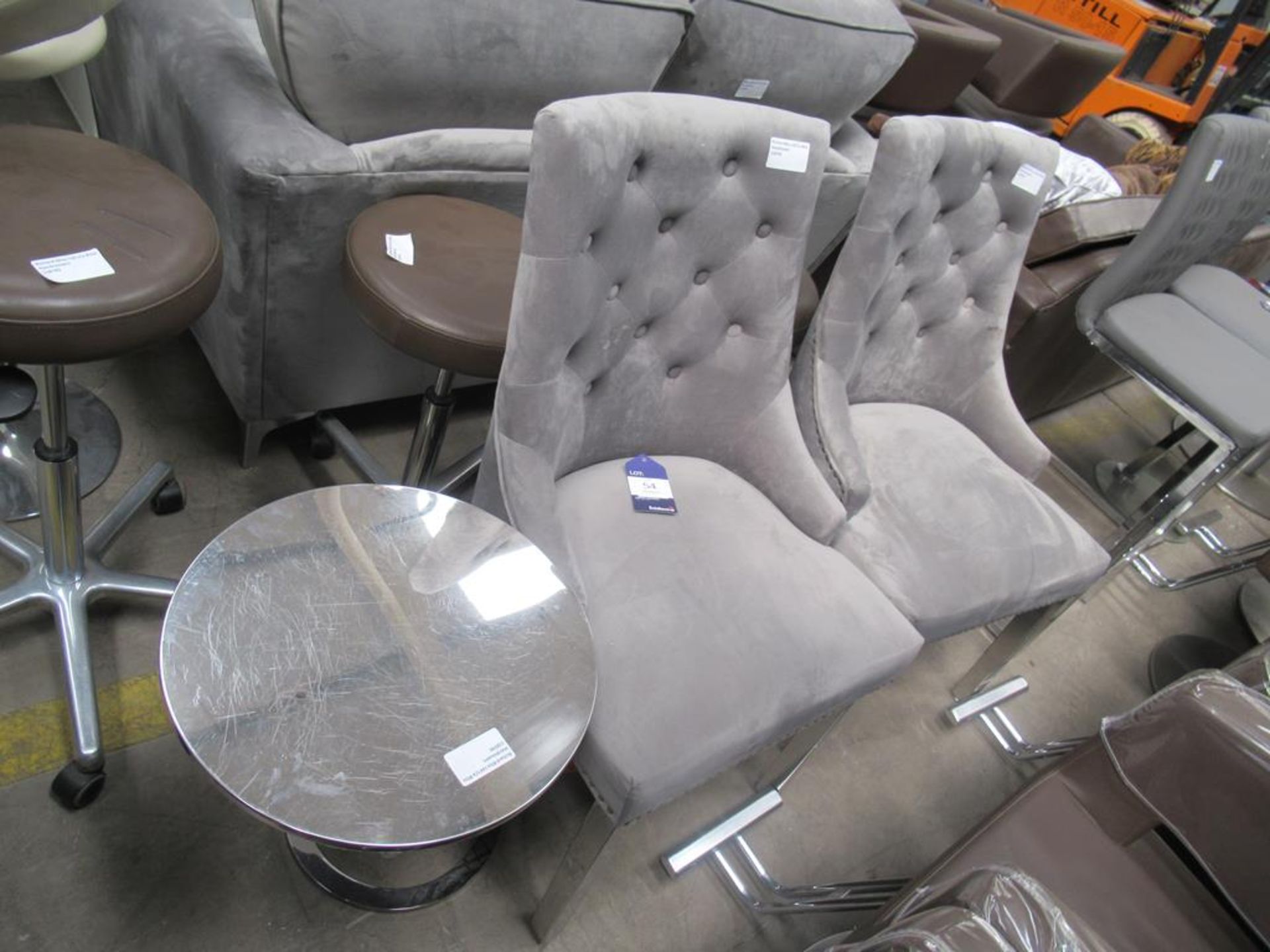 A pair of grey and chrome chairs with table