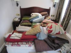 Large quantity of scatter cushions, throws, quilts and blankets in room 110