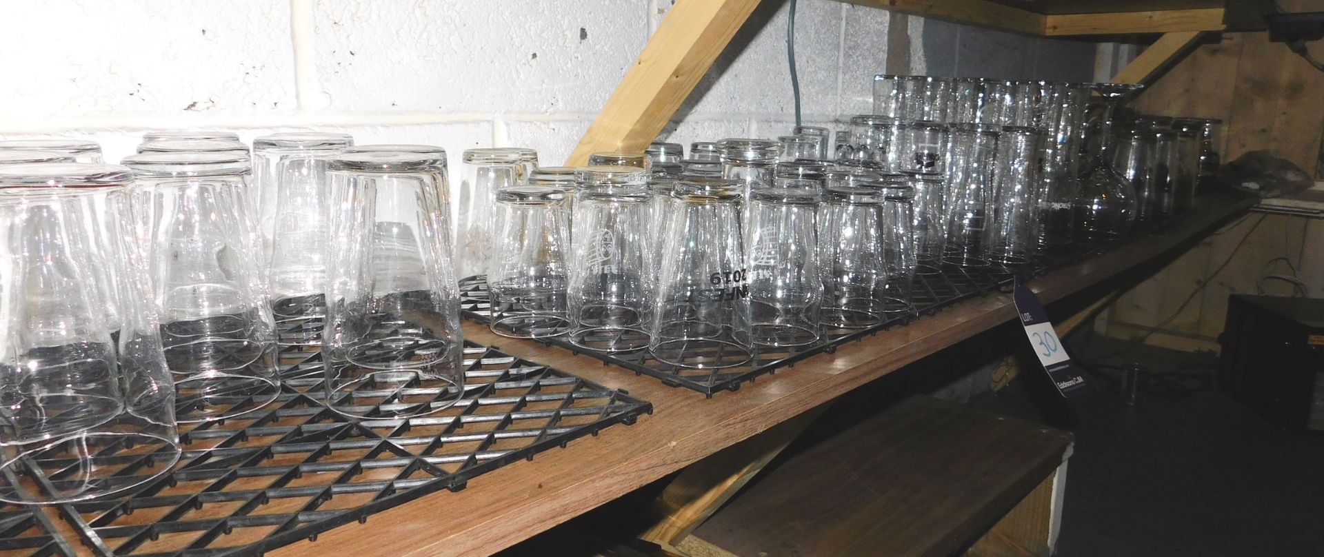 Glassware to shelf behind bar