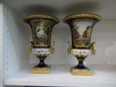 A pair of blue, white and gold painted urns