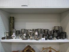 Shelf of metalware including two silver items