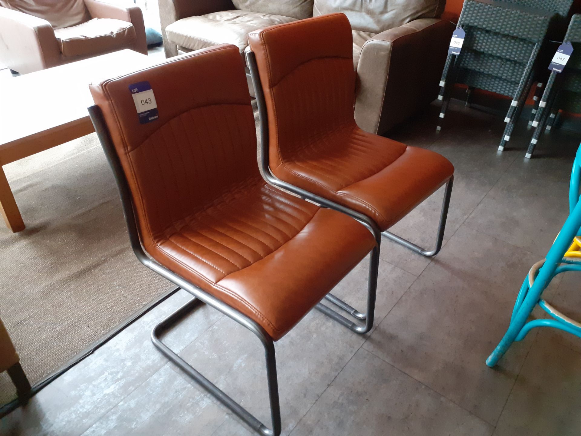 Pair of Nancy tubular steel chairs, brown vinyl