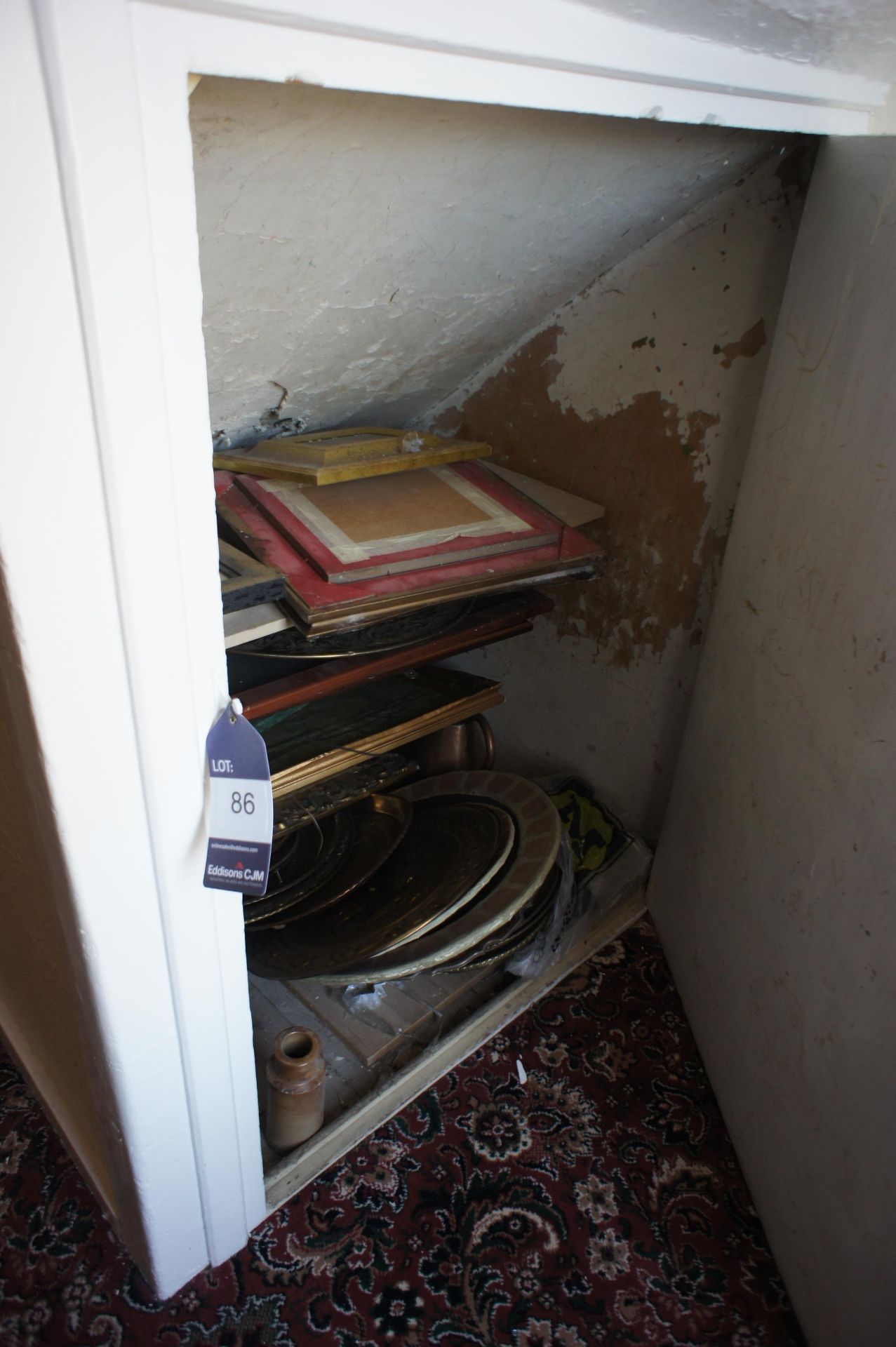 Loose contents of cupboard including Brass plates