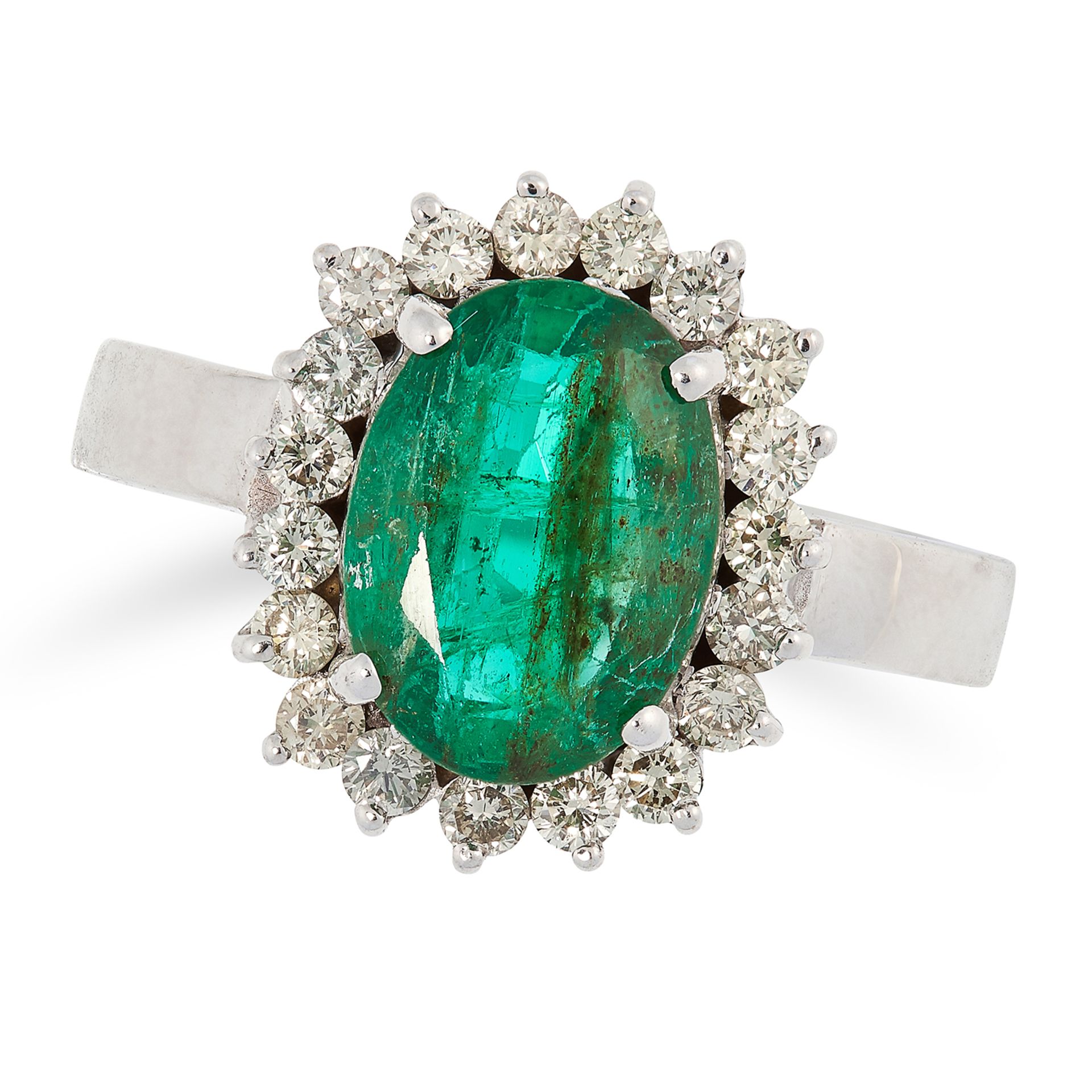 EMERALD AND DIAMOND CLUSTER RING set with an oval cut emerald in a cluster of round cut diamonds,