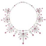 ANTIQUE RUBY, DIAMOND AND PEARL NECKLACE in foliate design set with cushion cut rubies totalling