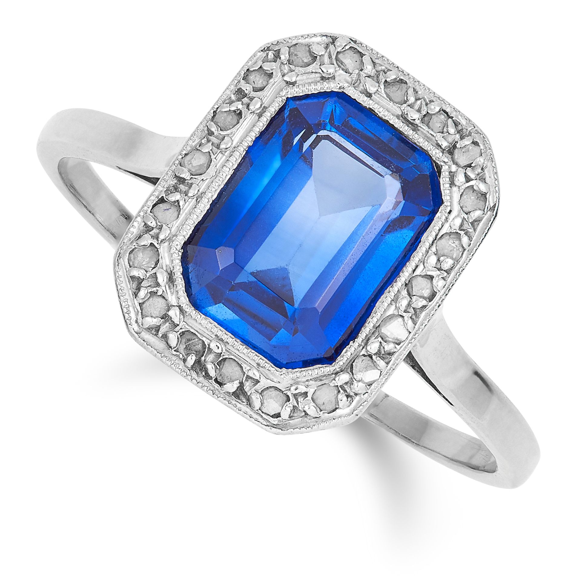 AN ART DECO SYNTHETIC SAPPHIRE AND DIAMOND CLUSTER RING set with an emerald cut synthetic sapphire