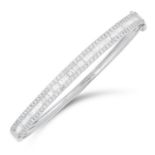 A DIAMOND BANGLE set with baguette cut and round modern brilliant cut diamonds totalling 1.50