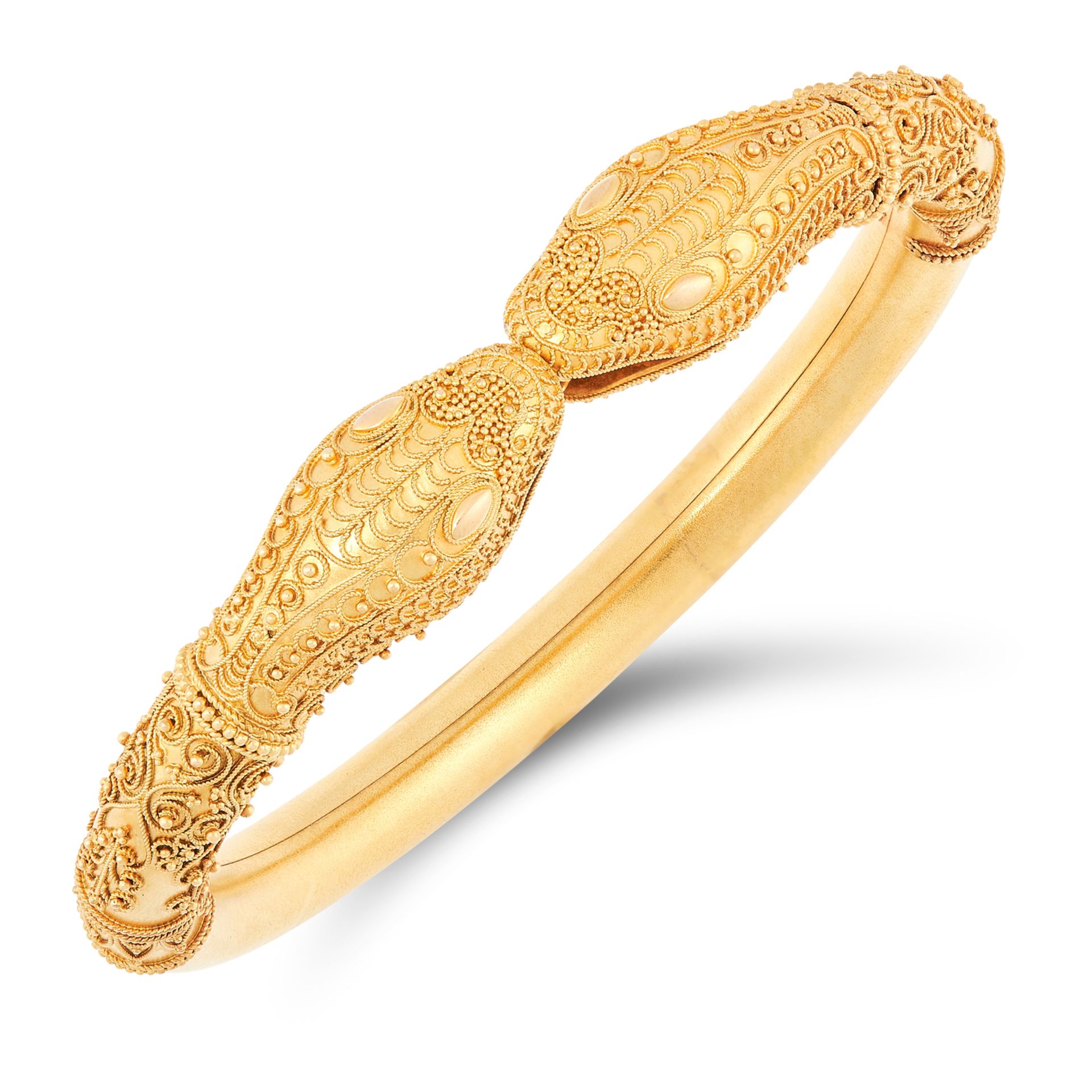 AN ANTIQUE DOUBLE SNAKE HEAD BANGLE, CIRCA 1879 in high carat yellow gold, the body designed as a