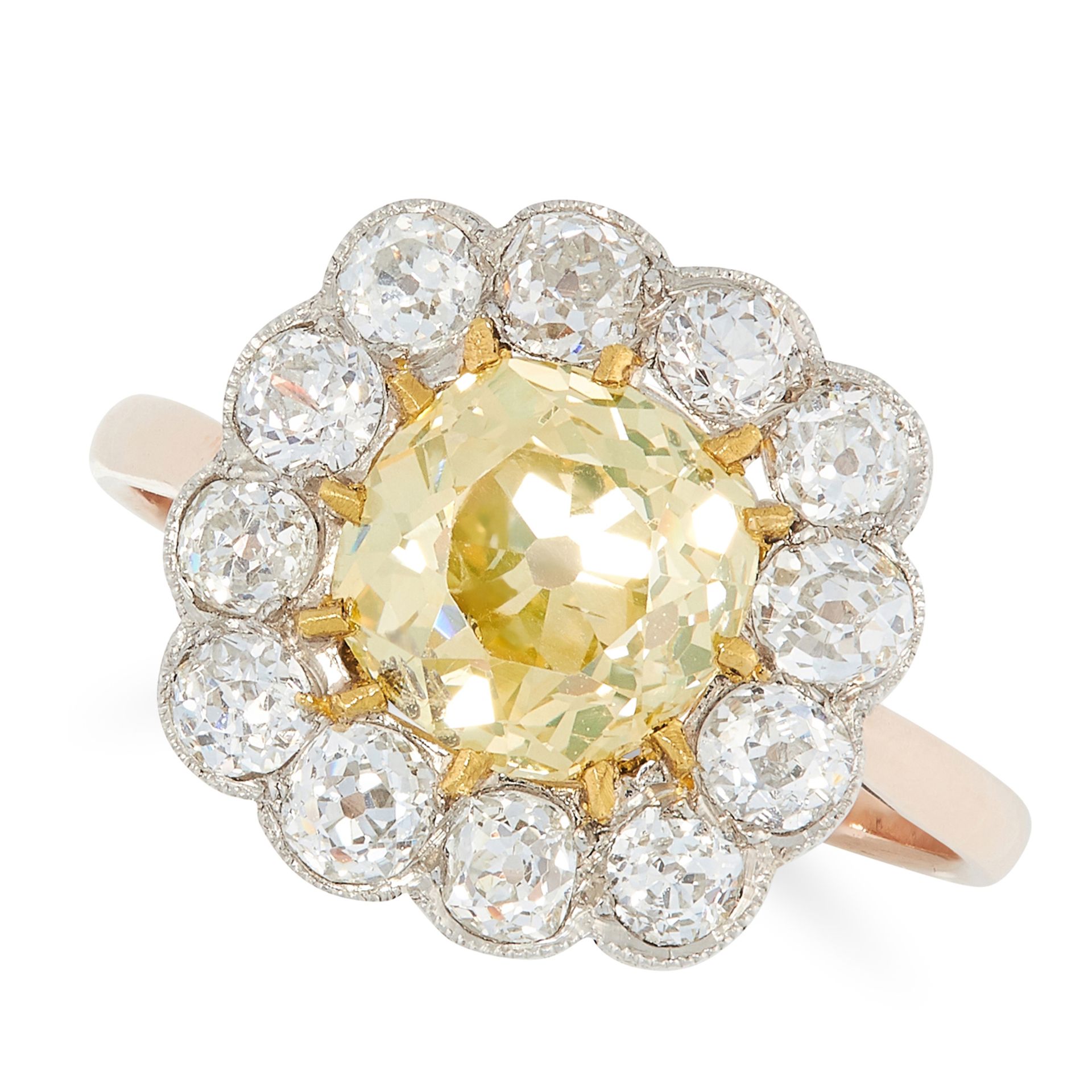A FANCY YELLOW DIAMOND CLUSTER RING in yellow gold, set with an old cut fancy yellow diamond of