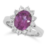 A SYNTHETIC PURPLE SAPPHIRE AND DIAMOND CLUSTER RING set with an oval cut purple sapphire in a