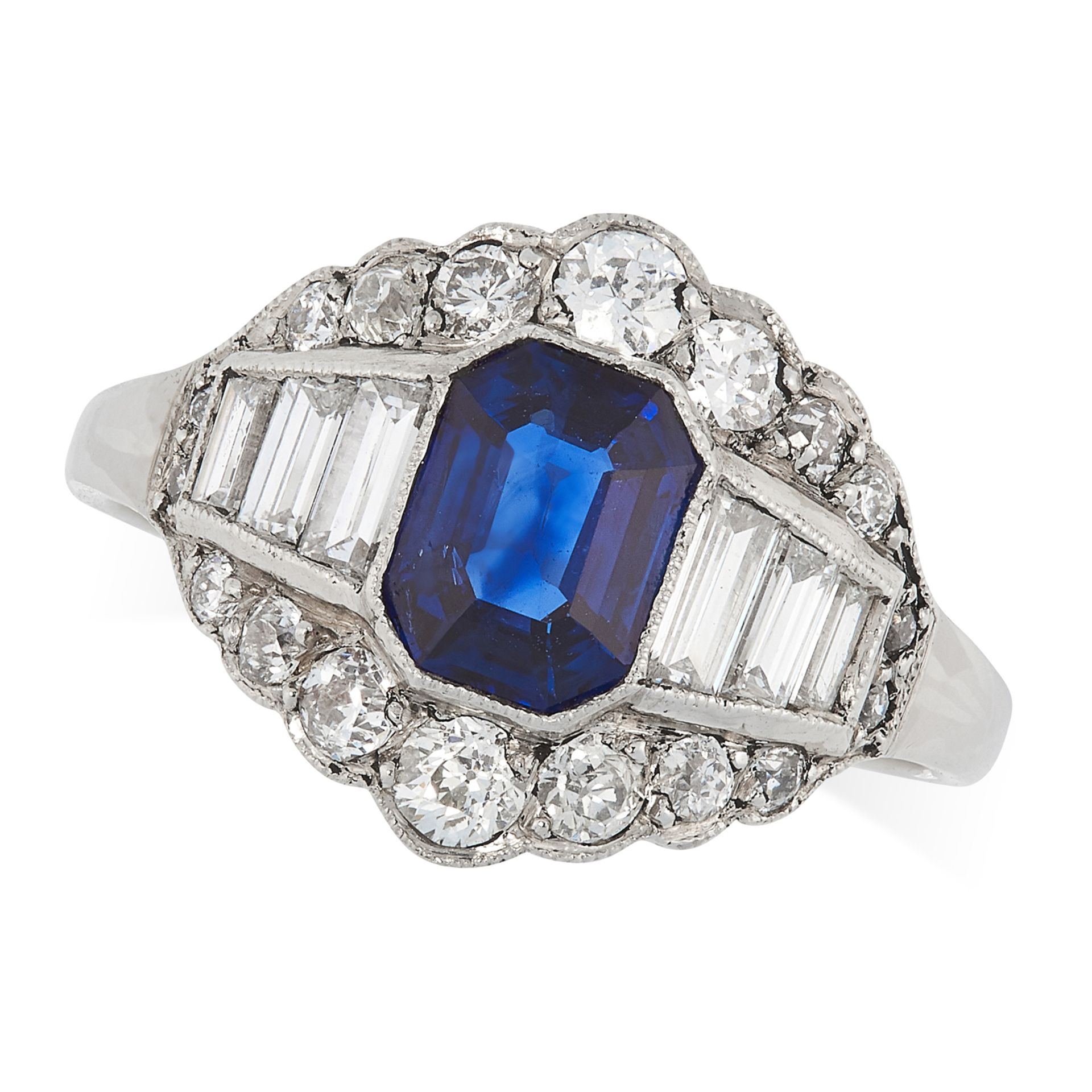 A SAPPHIRE AND DIAMOND DRESS RING set with an emerald cut sapphire, surrounded by round and baguette