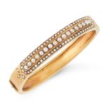AN ANTIQUE PEARL BANGLE, LATE 19TH CENTURY in high carat yellow gold, half set with three rows of