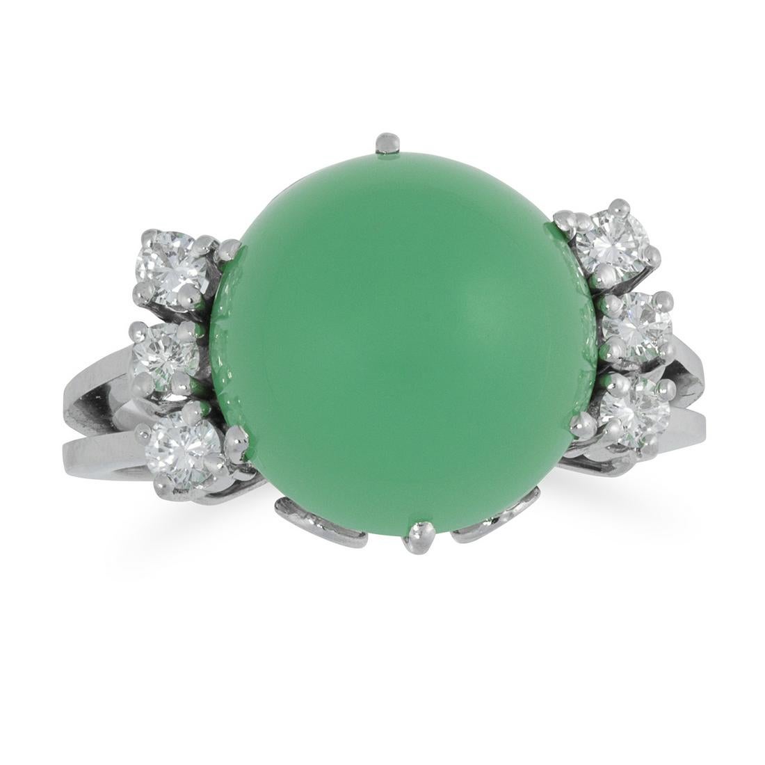 A CHRYSOPRASE AND DIAMOND RING set with a round cabochon chrysoprase between trios of round cut