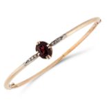 AN ANTIQUE SPINEL AND DIAMOND BANGLE set with an oval cut spinel between rose cut diamonds, in