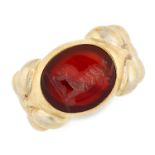 AN ANTIQUE CARVED CARNELIAN INTAGLIO SIGNET RING in high carat yellow gold, set with an oval