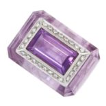 AN AMETHYST AND DIAMOND DRESS RING the carved and polished amethyst body set to the top with a