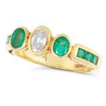 AN EMERALD AND DIAMOND RING in yellow gold, set with an oval cut diamond between oval cut
