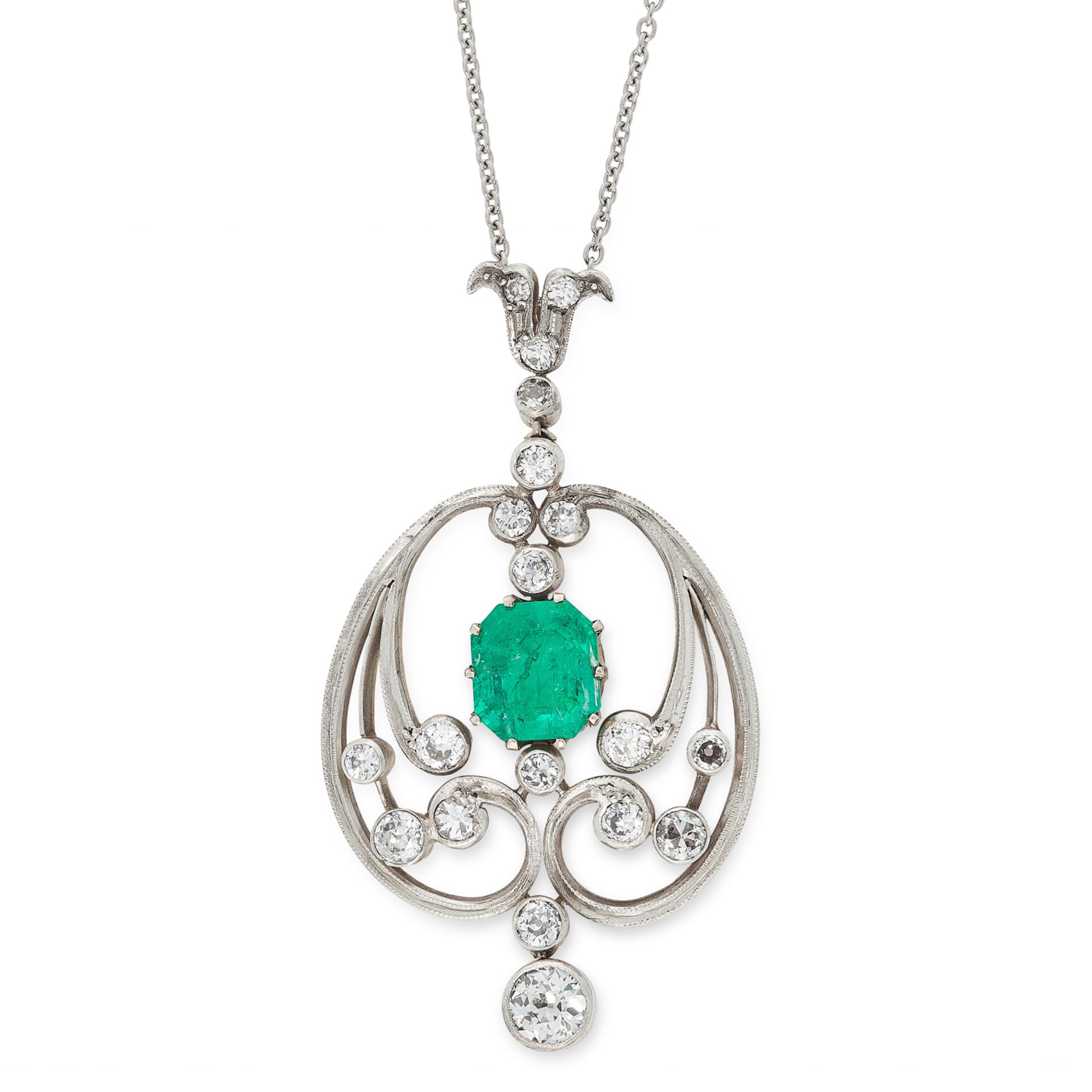 AN ART NOUVEAU EMERALD AND DIAMOND PENDANT in yellow gold and silver, set with a central emerald cut