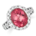 A PINK TOURMALINE AND DIAMOND DRESS RING, set with a faceted oval cut tourmaline and round cut